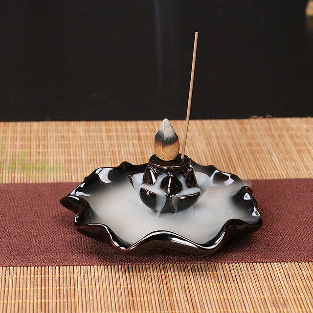 Incense burner with incense stick on a woven mat