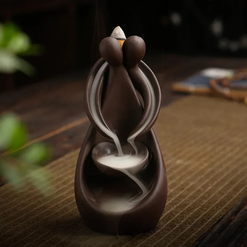 Ceramic incense burner with smoke on a wooden surface